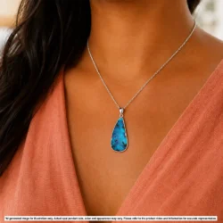 Green and blue Australian boulder opal pendant shown worn on a silver chain for illustrative styling reference