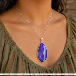 Natural 59.5 ct Winton boulder opal pendant shown worn on a silver chain with purple green color and teardrop shape
