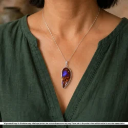 Purple Australian boulder opal fang tooth pendant shown worn on a silver chain with natural brown matrix