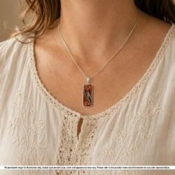 Hand carved blue green Australian boulder opal pendant shown worn on a silver chain with natural brown matrix