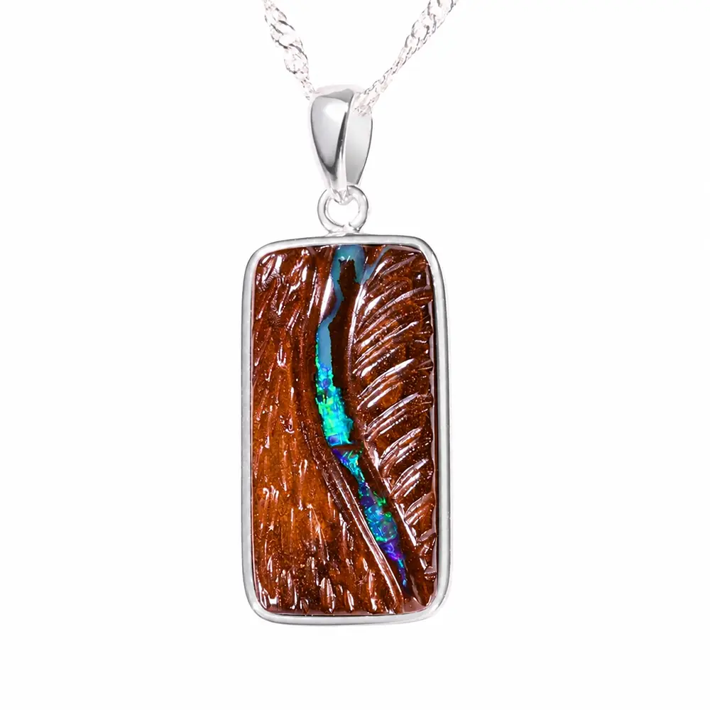 Shop a 23.5ct blue green boulder opal pendant from Winton Australia, hand carved with natural matrix and set in rhodium plated sterling silver.