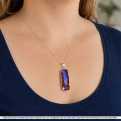Natural purple Australian boulder opal pendant with brown wood fossil matrix shown worn on a silver chain