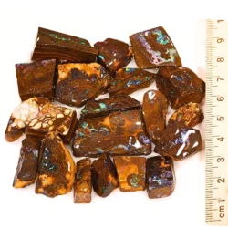 94g Boulder Opal matrix rubs from Winton Australia showing 20 natural pieces with rainbow color beside a ruler