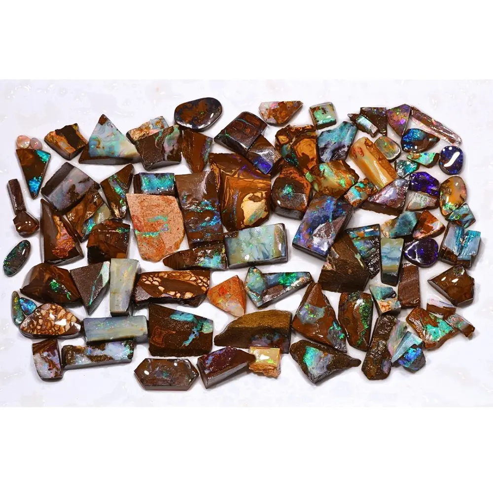 Full view of 85 natural Boulder Opal rubs from Winton Australia showing blue green turquoise and purple color in ironstone matrix