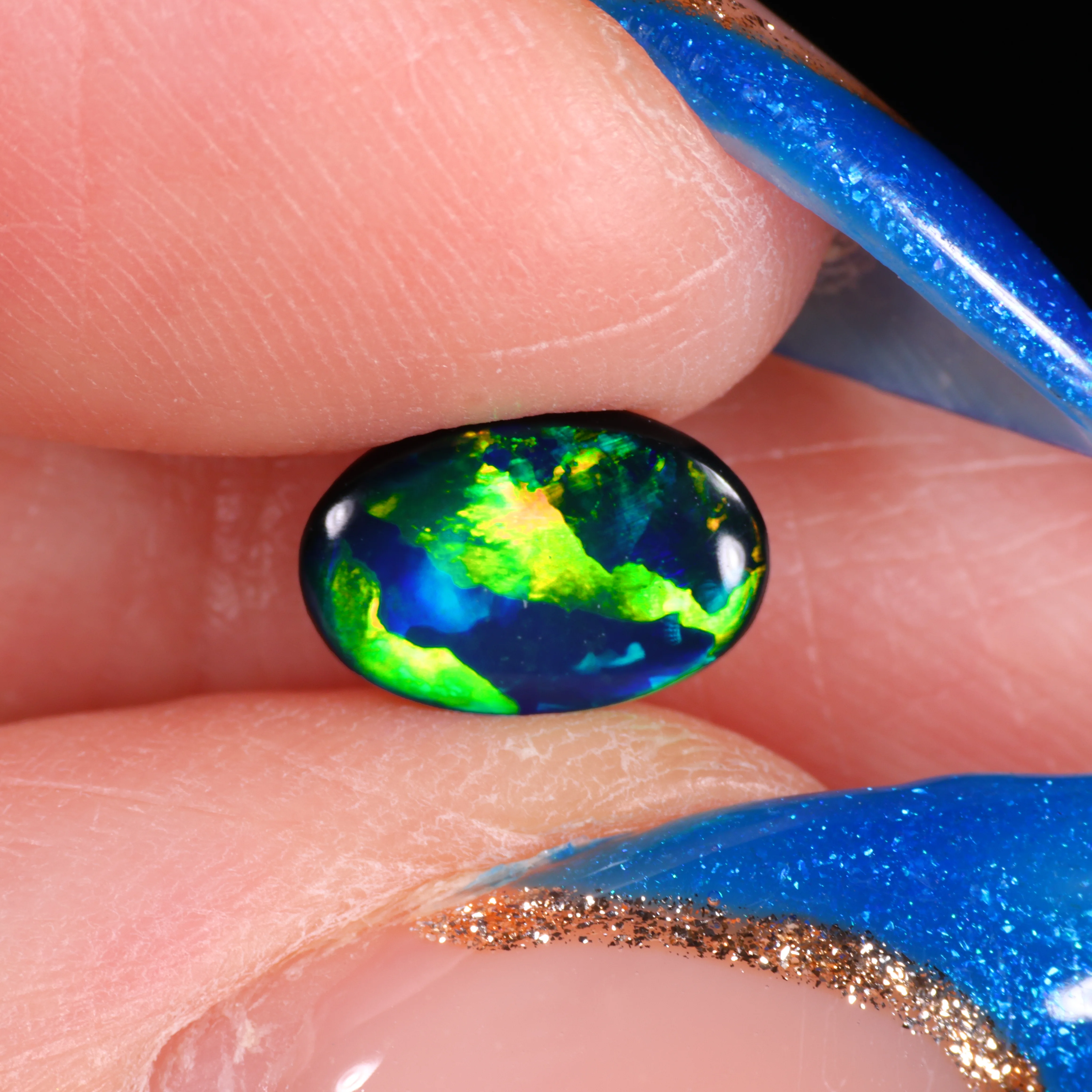 jet-black-opal-gemstone-finger-display-0-65ct-opal-galaxy