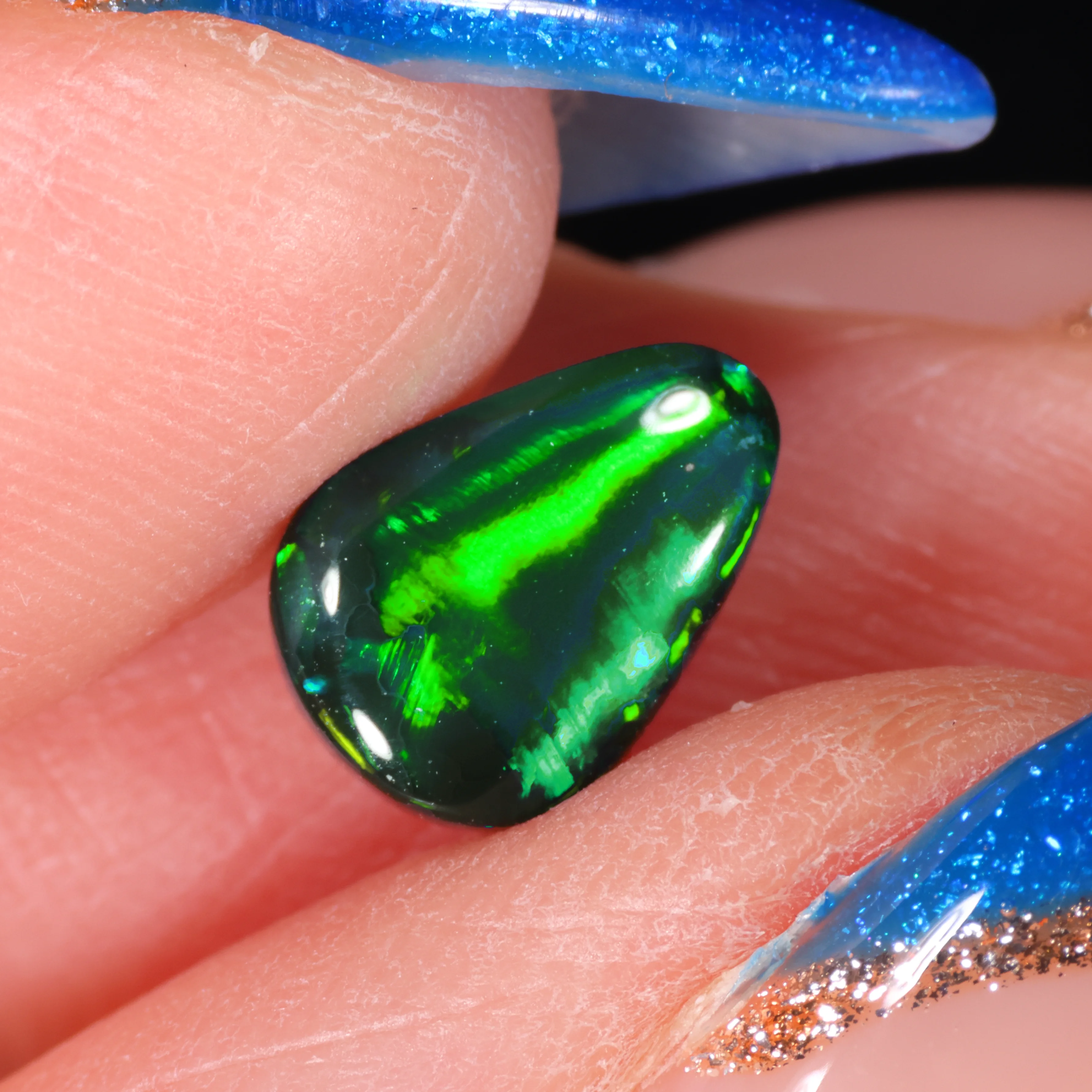 jet-black-opal-gemstone-finger-display-1-05ct-opal-galaxy