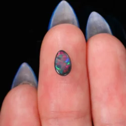 natural-black-opal-gemstone-finger-display-0-49ct-opal-galaxy