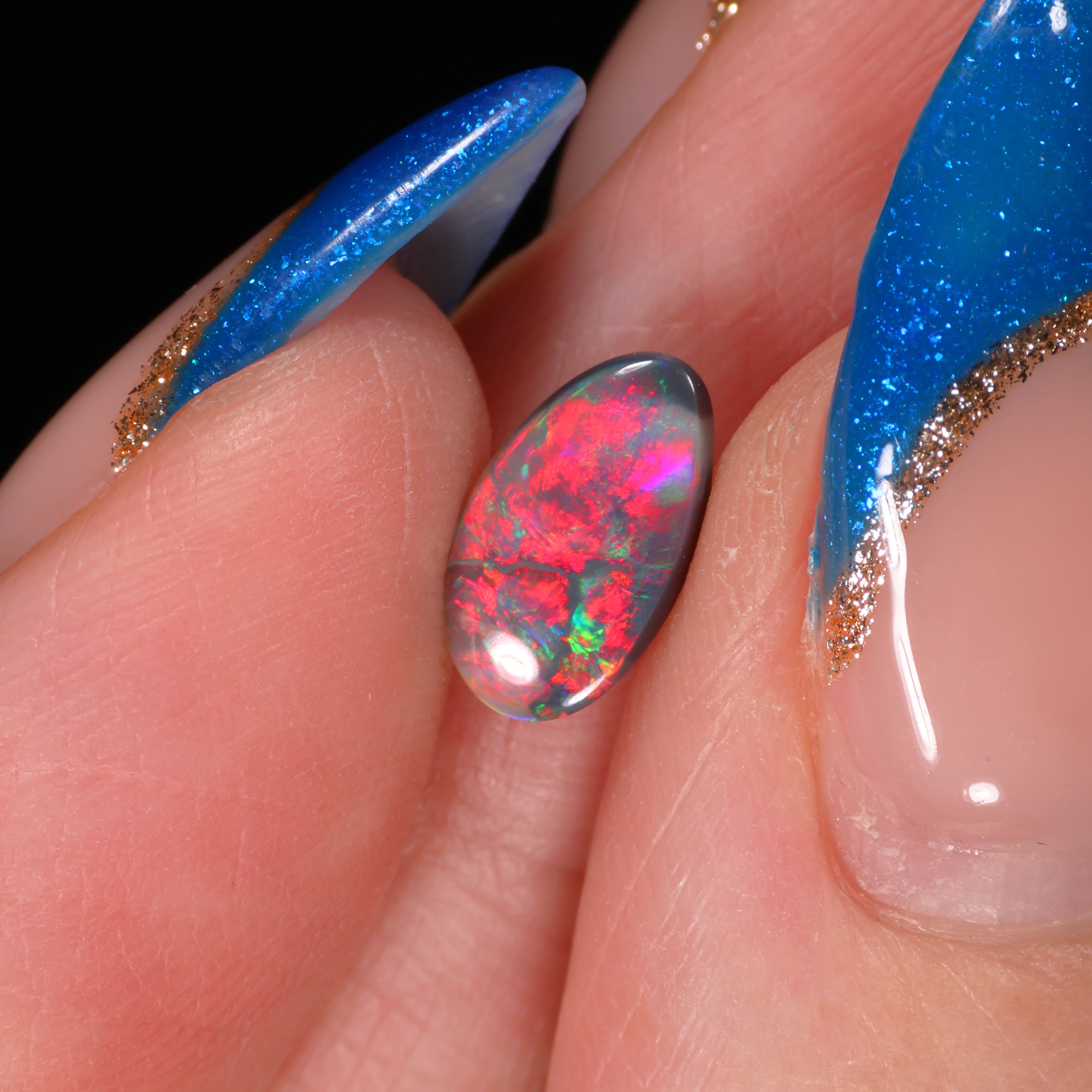 natural-dark-opal-gemstone-finger-display-0-7ct-opal-galaxy