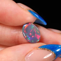 natural dark opal oval on finger scale display 2 25ct opal galaxy