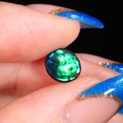 round-black-opal-gemstone-finger-display-0-98ct-opal-galaxy