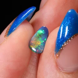 teardrop-black-opal-gemstone-finger-display-0-75ct-opal-galaxy