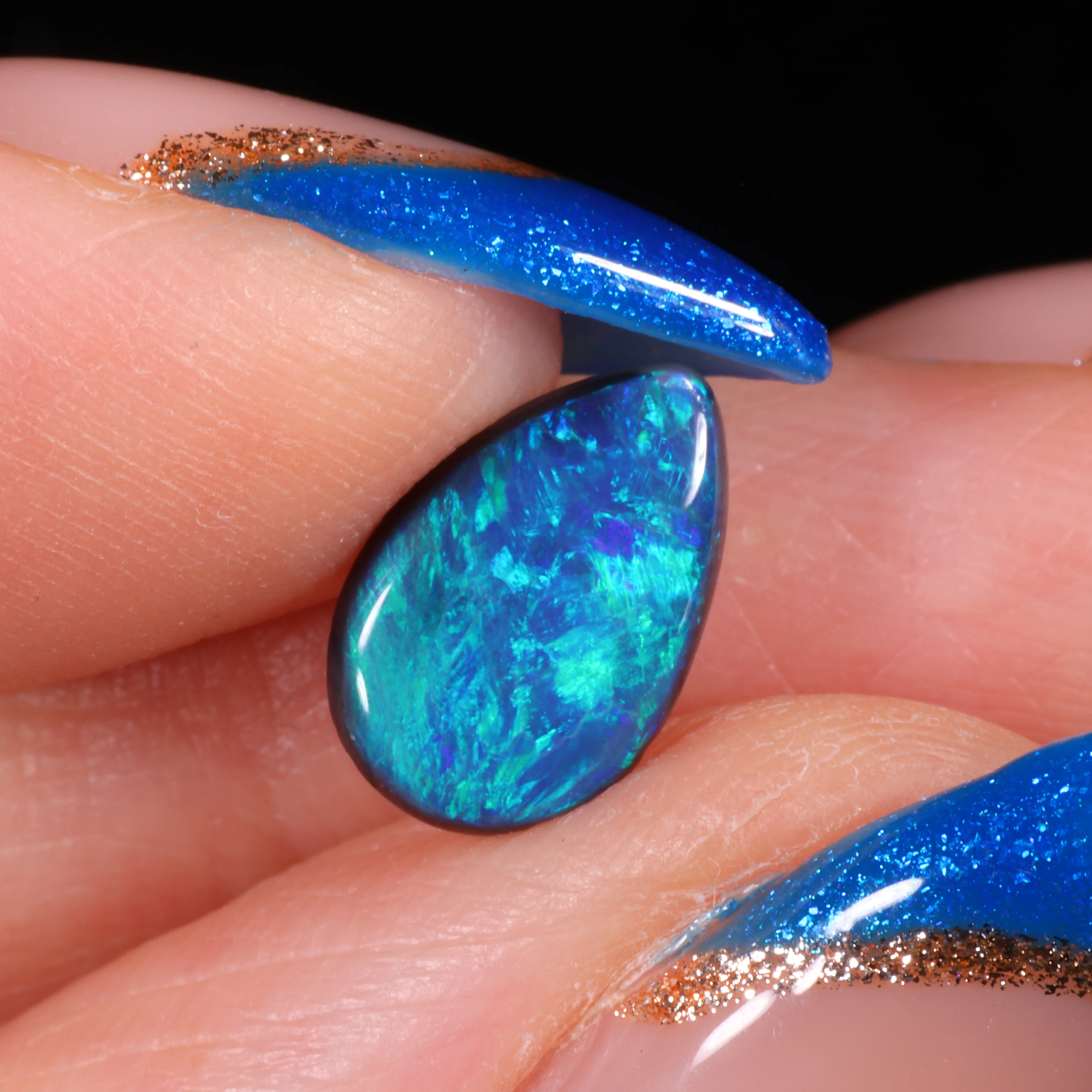 teardrop-black-opal-gemstone-finger-display-1-15ct-opal-galaxy
