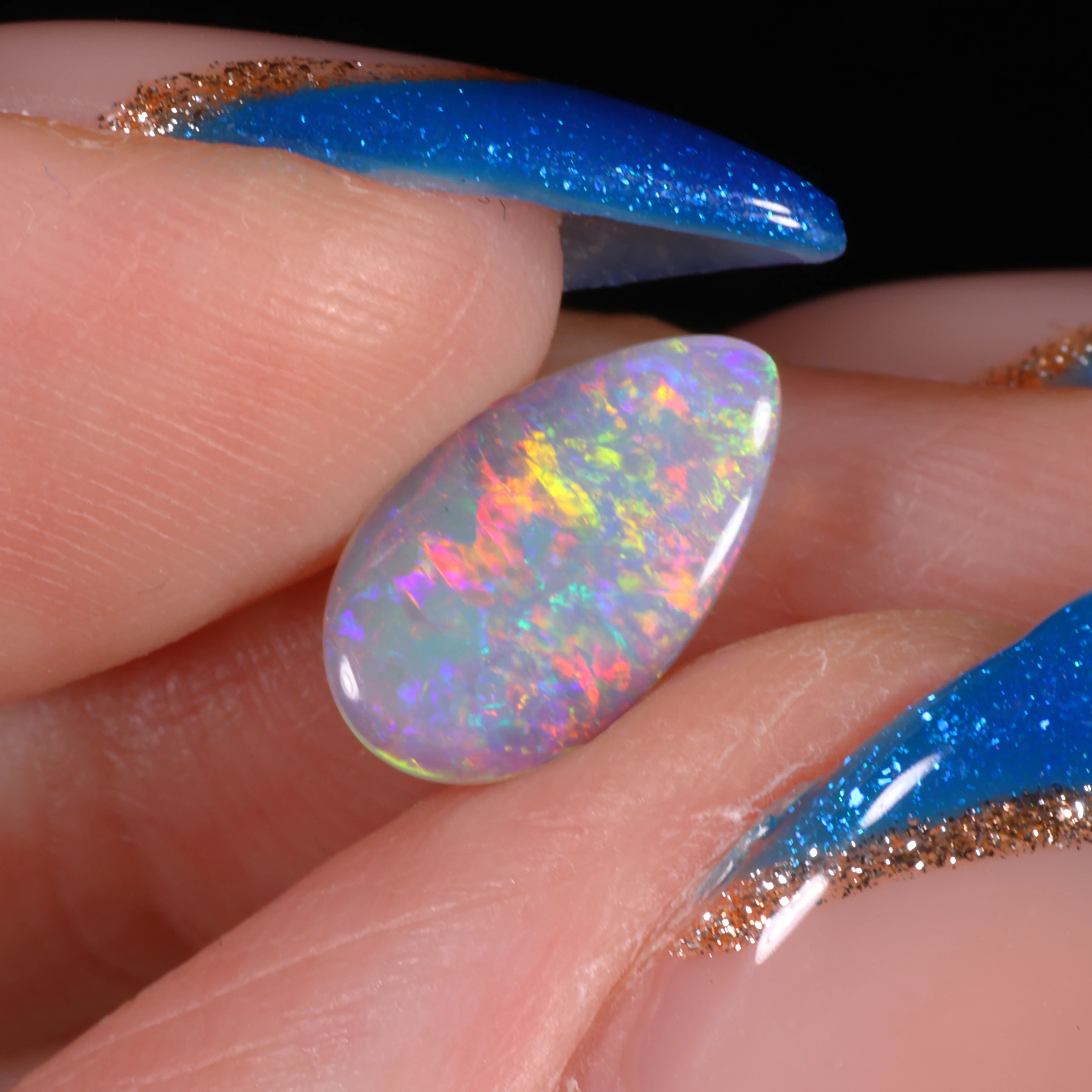 teardrop-dark-crystal-opal-finger-display-0-64ct-opal-galaxy