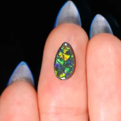 australian-black-opal-pear-finger-scale-on-hand-1-66ct-opal-galaxy