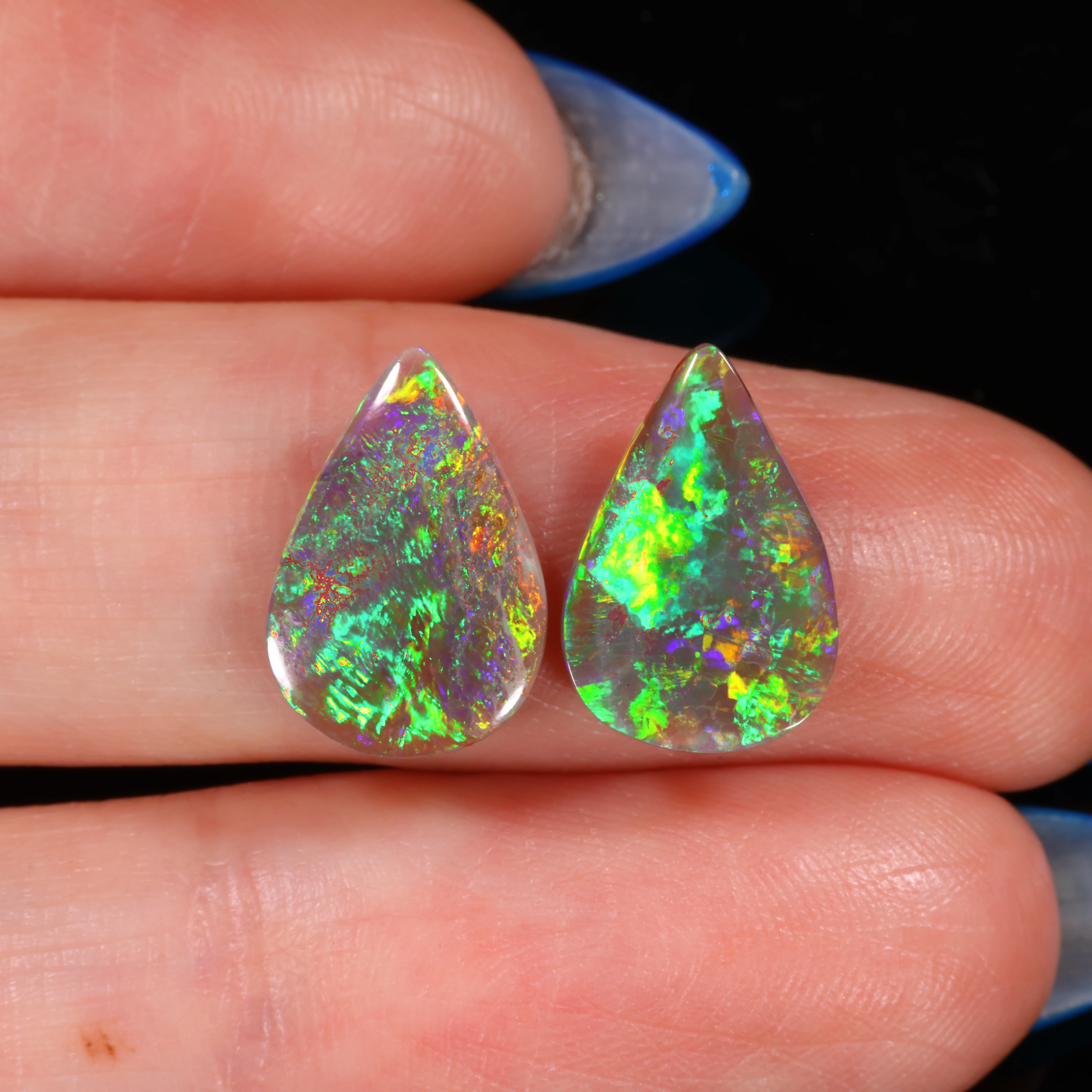 australian-dark-opal-pair-finger-scale-on-hand-3-68ct-opal-galaxy