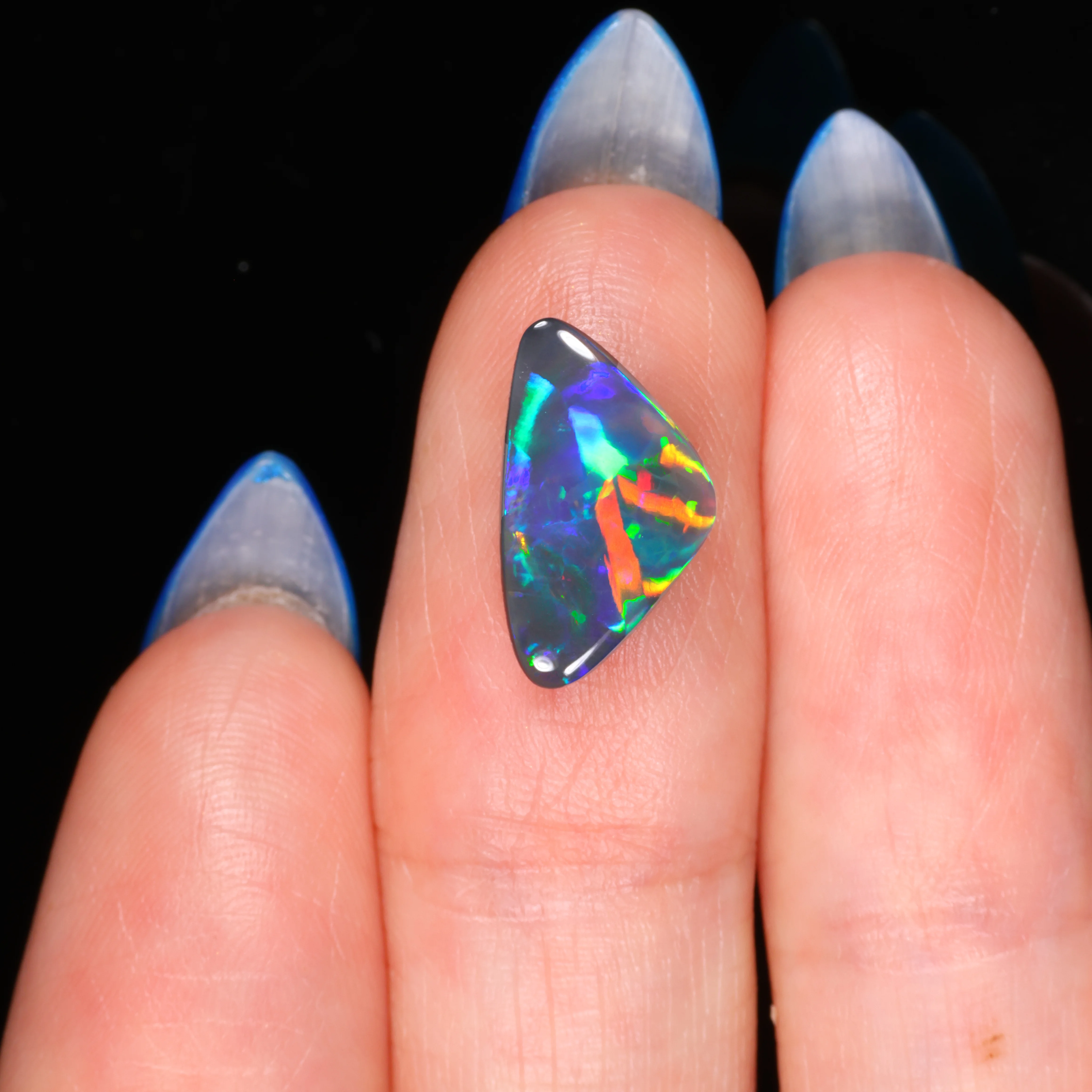 loose-australian-black-opal-on-hand-finger-scale-opal-galaxy