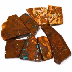 Overhead view of 8 Australian Boulder Opal rubs from Winton, Queensland, featuring natural brown ironstone, cream matrix formations and scattered blue green opal color.