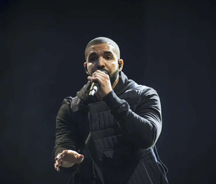 Drake performing on stage, an October born celebrity linked to rising October birthstone opal demand in the 2026 Australian opal market