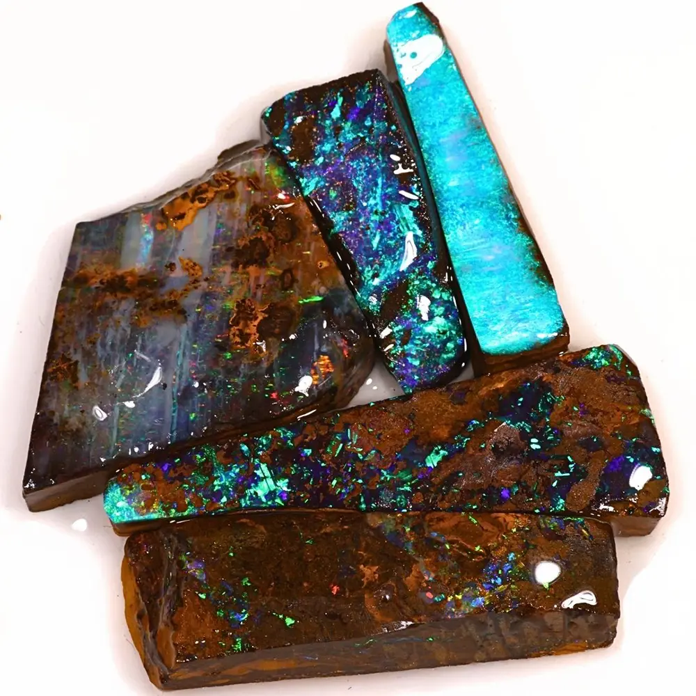 Natural Winton Boulder Opal rubs showing vivid blue and green play of color, purple flashes and intricate rainbow patterns across five partially worked gemstones.